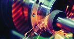 Finishing metal working on high precision grinding machine in workshop Finishing metal working on high precision grinding machine in workshop